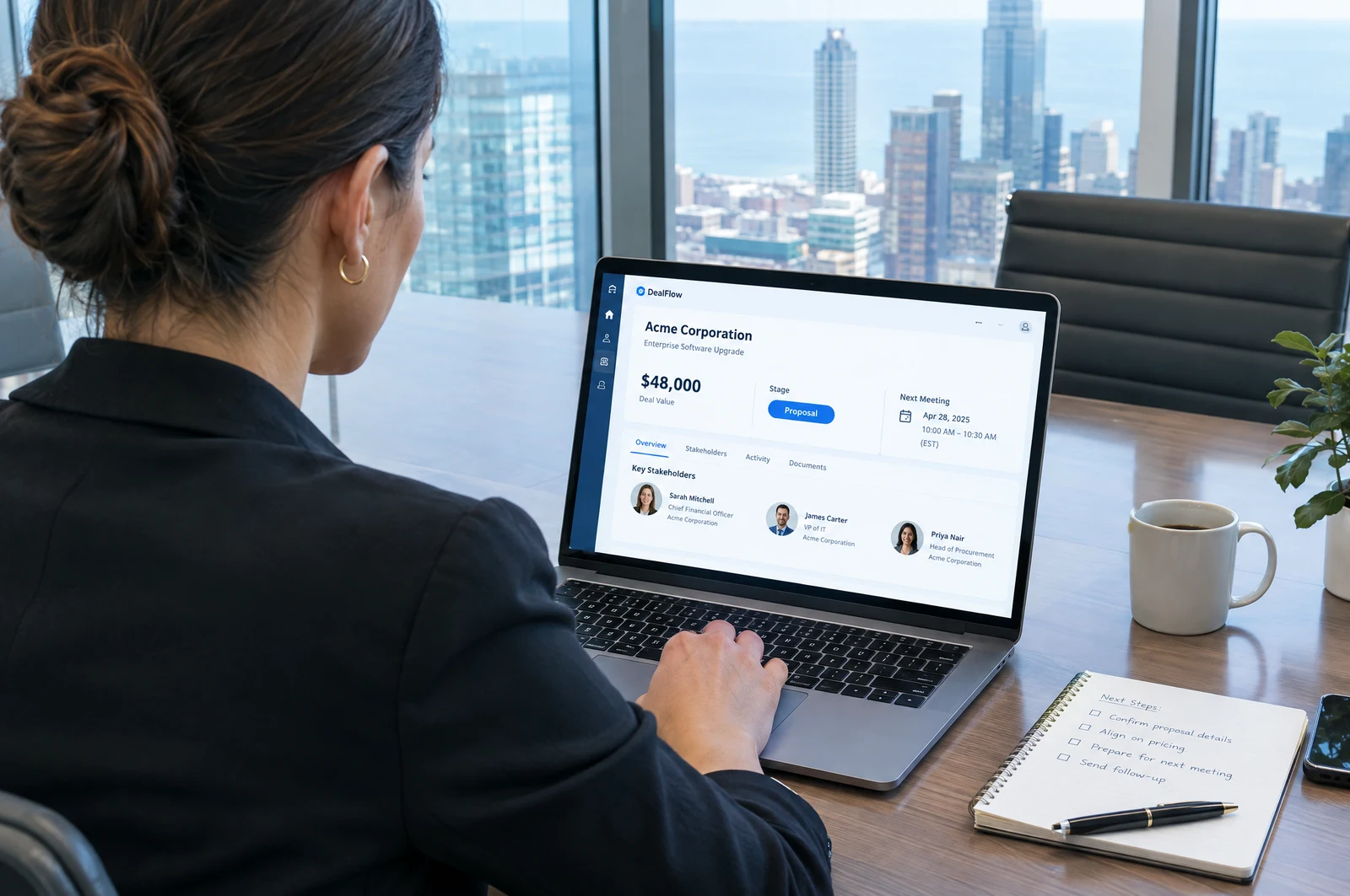 An account executive in a meeting room reviewing a deal page with deal value, stage, and stakeholders